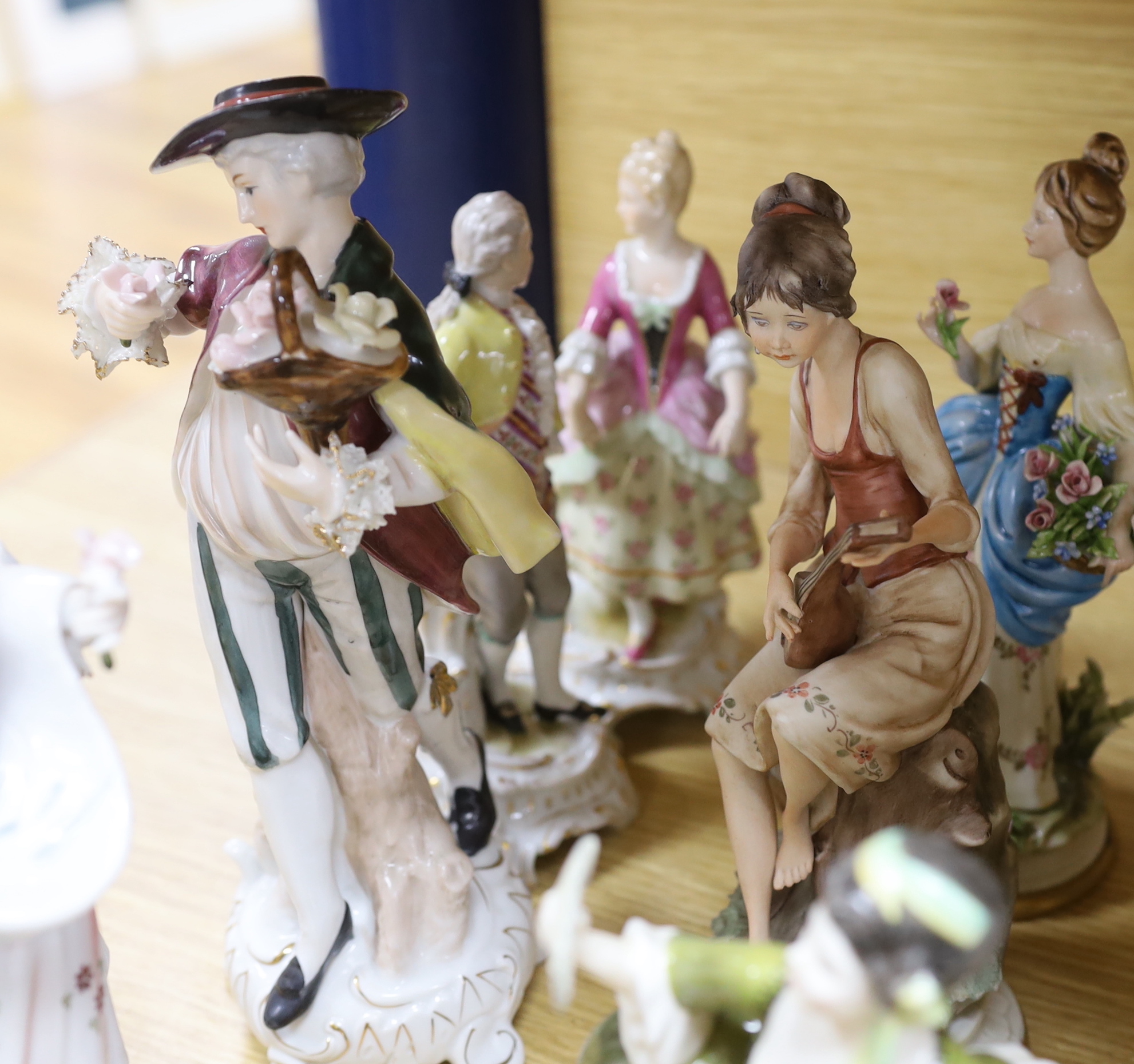 A collection of various porcelain figures including Coalport, Doulton etc. and two dessert plates